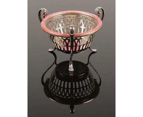 An early 20th century white metal basked. Raised on three scrolling feet and decorated with pink guilloche enamel.  