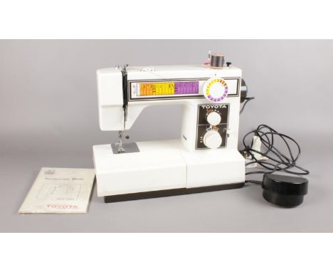 A Toyota sewing machine - to include instruction manual &amp; foot pedal. H: 31cm, W:37cm, D: 15.5cm.  Condition good- machin