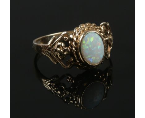 A 9ct gold opal ring with open work shoulders. Size N. 2.45g.  