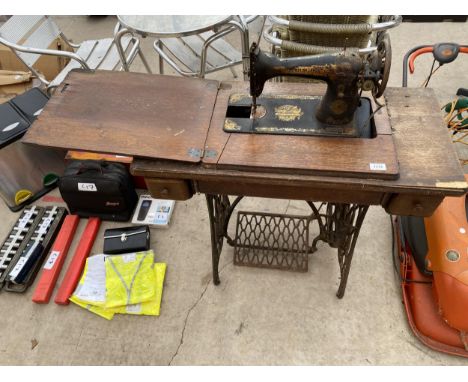 A VINTAGE SINGER SEWING MACHINE WITH TREDDLE BASE 