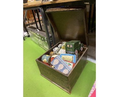 A VINTAGE WOODEN BOX CONTAINING A QUANTITY OF VINTAGE TINS, ETC 