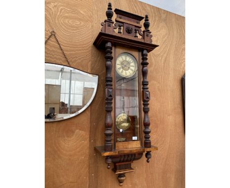 A DECORATIVE VIENNA WALL CLOCK WITH KEY AND LIONMS HEAD DECORATION 