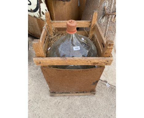 A LARGE VINTAGE GLASS CARBOY WITH RUBBER STOPPER 