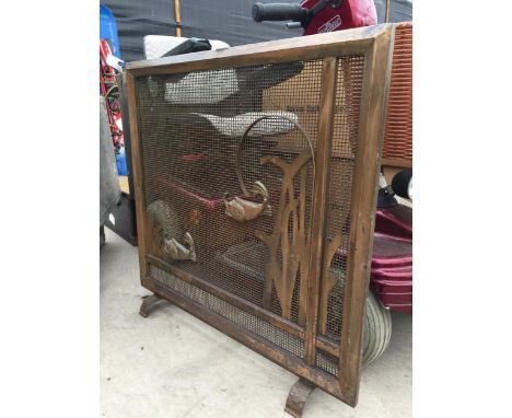 A DECORATIVE BRASS FIRE SCREEN WITH FISH DECORATION 