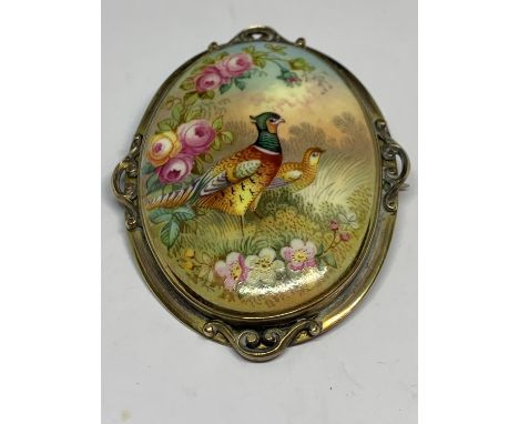A LARGE CERAMIC BROOCH WITH A PHEASANT DESIGN 