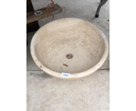 A CREAM WASH BASIN FORMED FROM A SOLID PIECE OF MARBLE 