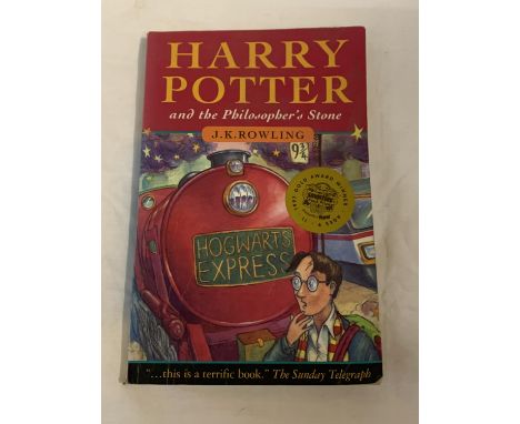 A FIRST EDITION (30TH PRINT) HARRY POTTER AND THE PHILOSOPHER'S STONE PAPERBACK BOOK BY J.K. ROWLING. PUBLISHED BY BLOOMSBURY