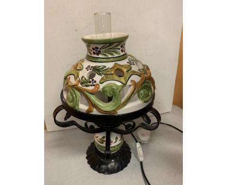 A MEDITERRANEAN STYLE WROUGHT IRON AND CERAMIC LAMP 
