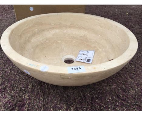 A CREAM WASH BASIN FORMED FROM A SOLID PIECE OF MARBLE 