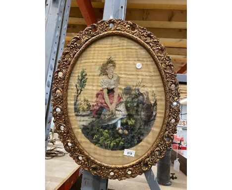 AN OVAL GILT FRAMED TAPESTRY OF A LADY 