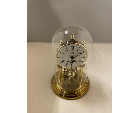 A GLASS DOMED MANTLE CLOCK WITH RISING MOON 