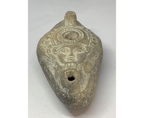 AN EGYPTIAN OIL LAMP 
