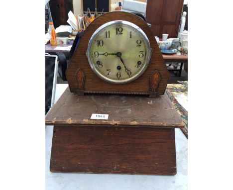 A VINTAGE WOODEN CASED MANTLE CLOCK WITH WOODEN PLINTH BASE 