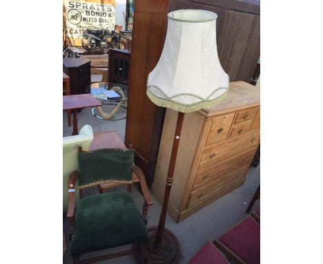 AN OAK ELBOW CHAIR AND STANDARD LAMP COMPLETE WITH SHADE 
