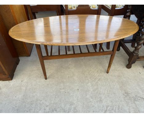 A RETRO TEAK OVAL COFFEE TABLE WITH MAGAZINE SHELF 