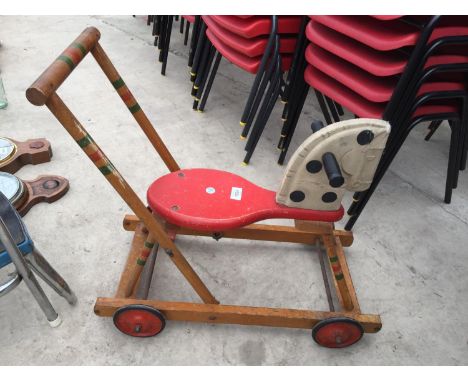 A VINTAGE WOODEN CHILDRENS PUSH ALONG HORSE 