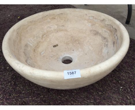 A CREAM WASH BASIN FORMED FROM A SOLID PIECE OF MARBLE 
