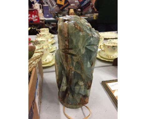 A LAMP CARVED FROM POSSIBLY SEMI PRECIOUS STONE WITH TWO FACES CARVED INTO IT 
