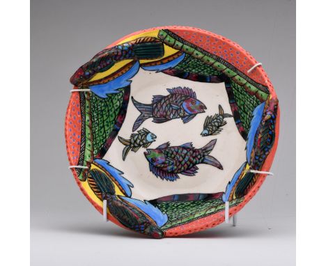 Centrally painted with fish, on a white ground, with fish scales and an abstract pattern on the inside of the bowl, and appli