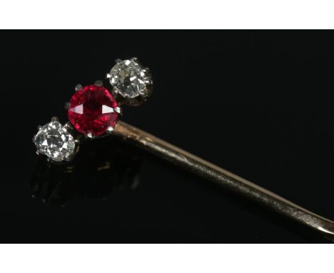 A Victorian yellow metal, diamond and ruby coloured stone stick pin.  