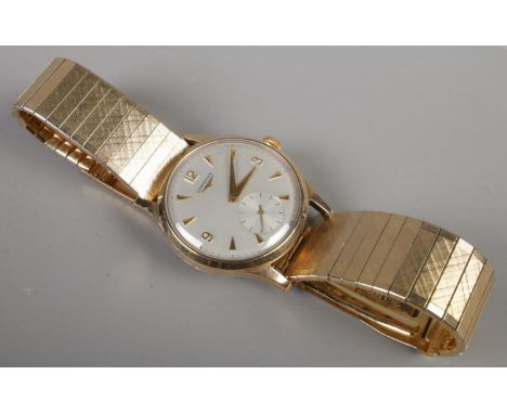 A gents 9ct gold Longines manual wristwatch on stainless steel bracelet strap. Having baton and Arabic numeral markers and su