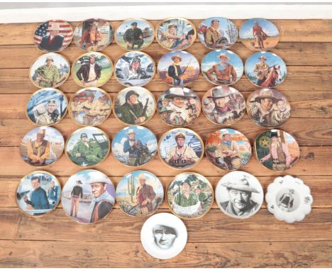 A large collection of John Wayne ceramic cabinet plates, including over twenty Franklin Mint examples. Most with polystyrene 