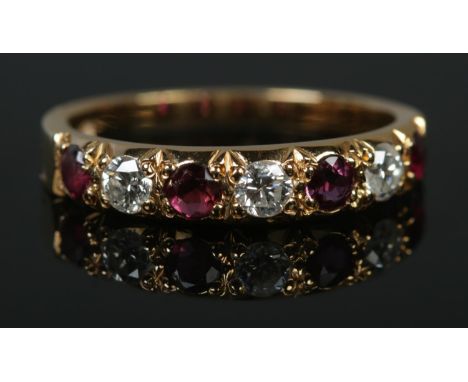 An 18ct gold diamond and ruby seven stone ring. Assayed for Sheffield 1981, makers mark J&amp;P. Size N. 2.56g.  