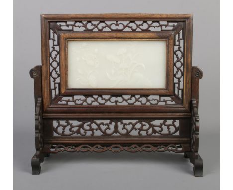 A Chinese Qing dynasty carved hardwood and white jade table screen. The panel carved in relief with butterflies and flowers a