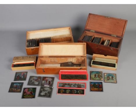 Three cases of coloured magic lantern slides including several sets such as The Transvaal War and Jessica's First Prayer.  