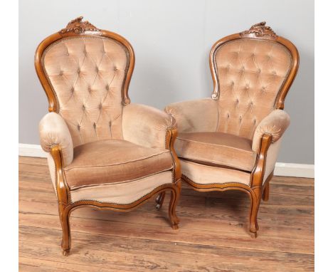 A pair of French style hardwood arm chairs with deep button backs.  