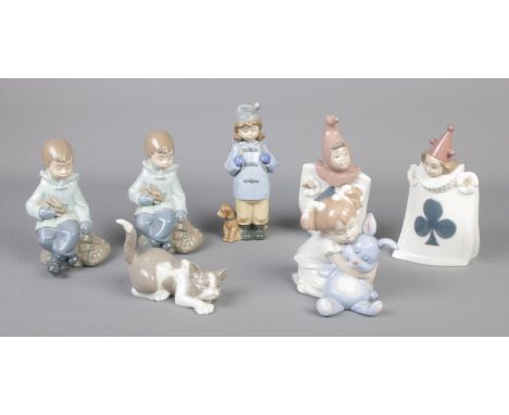 Six Nao by Lladro ceramic figures, together with a Lladro ceramic cat.  Rabbits ears have been repaired, hands missing from f