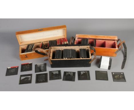 Three cases of photographic magic lantern slides including subjects such as portraits, tribes and landscapes.  