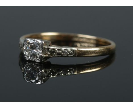 An Art Deco 18ct gold and platinum diamond solitaire ring. Size L. 1.98g. Approximately 0.25ct diamond.  