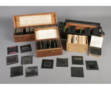Four cases of Magic Lantern Slides depicting an assortment of photographs with subjects including buildings, landscapes and n