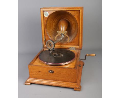 A Pathe The Elf tabletop record player featuring pressed bowl lid speaker.  Not working, large crack to lid.