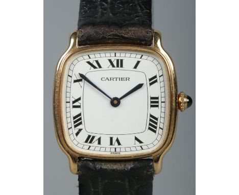 An 18ct gold Cartier manual wristwatch. Having Roman numeral markers. With leather strap and 18ct gold buckle. Box and papers