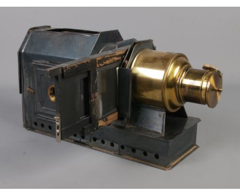 A magic lantern projector, unmarked with storage tin.  