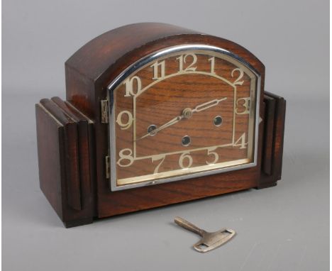 A 1930s oak mantel clock. The movement marked Haller A. With pendulum and key.  