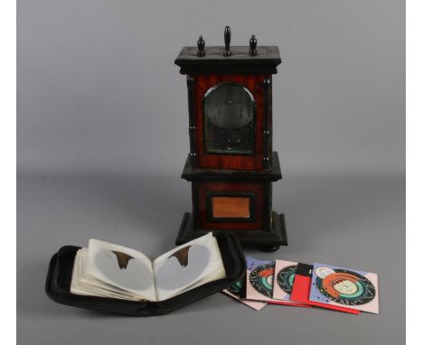 A miniature coin operated music polyphon. Approx. 45cm tall. Includes small selection of music discs including Down where the