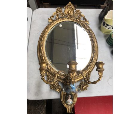 A 19TH CENTURY GILT FRAMED MIRROR WITH LOWER PORTRAIT PLAQUE AND THREE CANDLE BRANCH HOLDERS 