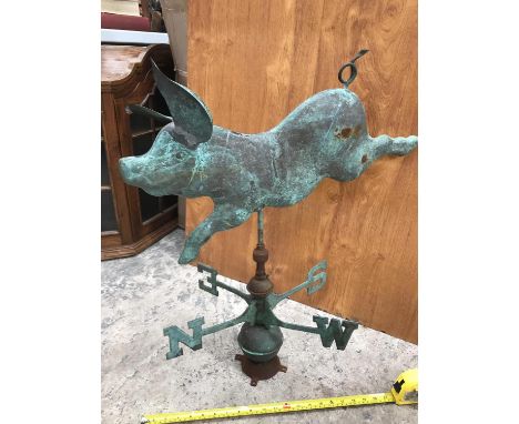 A VINTAGE COPPER WEATHER VANE OF A FLYING PIG 