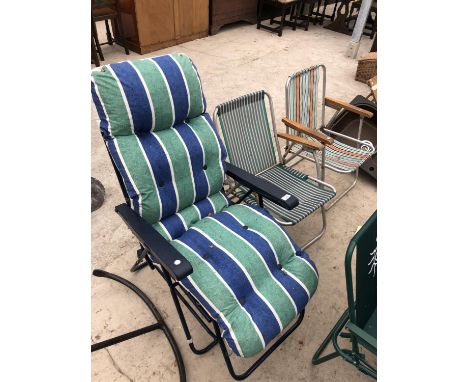 A RECLINING GARDEN SUNLOUNGER WITH CUSHION AND TWO VINTAGE METAL FRAMED FOLDING DECK CHAIRS WITH STRIPED CANVAS 