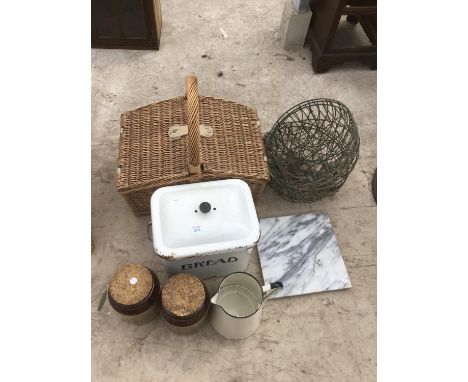 A WICKER PICNIC BASKET WITH ENAMEL BREAD BIN AND JUG, TWO STONEWARE JARS, A MARBLE CHOPPING BOARD AND HANGING BASKETS 