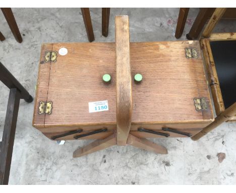 A VINTAGE OAK CONCERTINA SEWING BOX AND CONTENTS 
