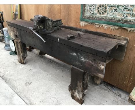 A VINTAGE PINE WORK BENCH WITH LARGE BENCH VICE 