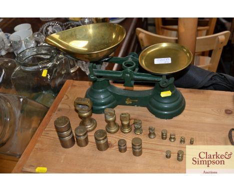 A set of kitchen scales and a quantity of graduating weights
