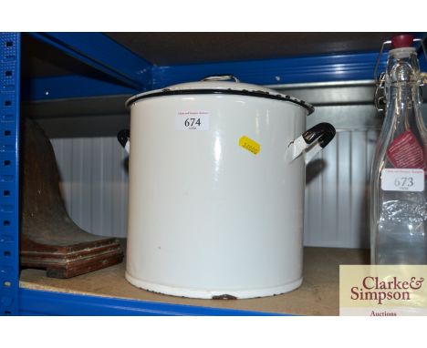 A circular enamel storage bin with lid