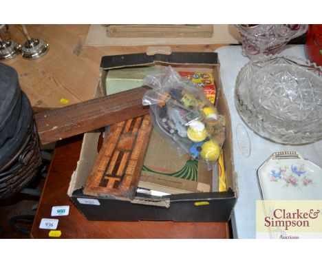 A box containing vintage toys, two cribbage boards, various postcards, postcard album and contents