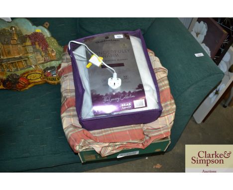A Slumberdown Wonderfully Warm electric blanket together with a pair of stripped curtains