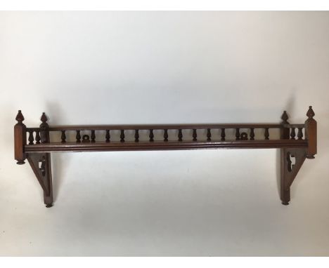 An early twentieth century wooden decorative shelf with carved finials A/FW:77cm x D:19cm x H:36cm